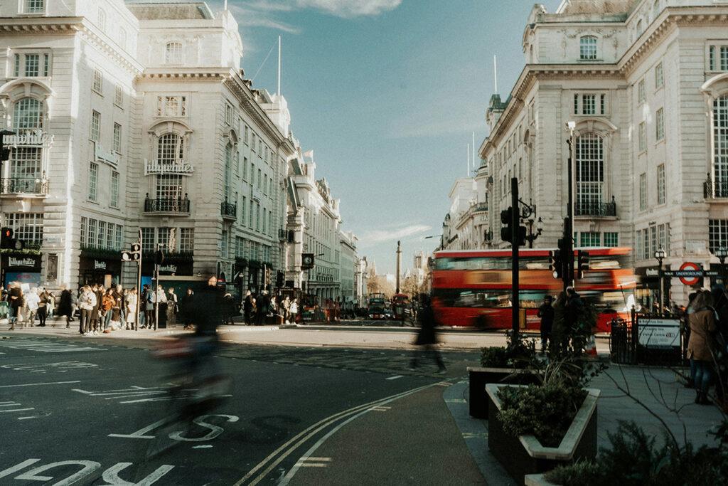 Oxford Street London with red iconic bus and shoppers